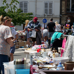 Mobilier exposé lors de la brocante et visiteurs qui regardent les stands